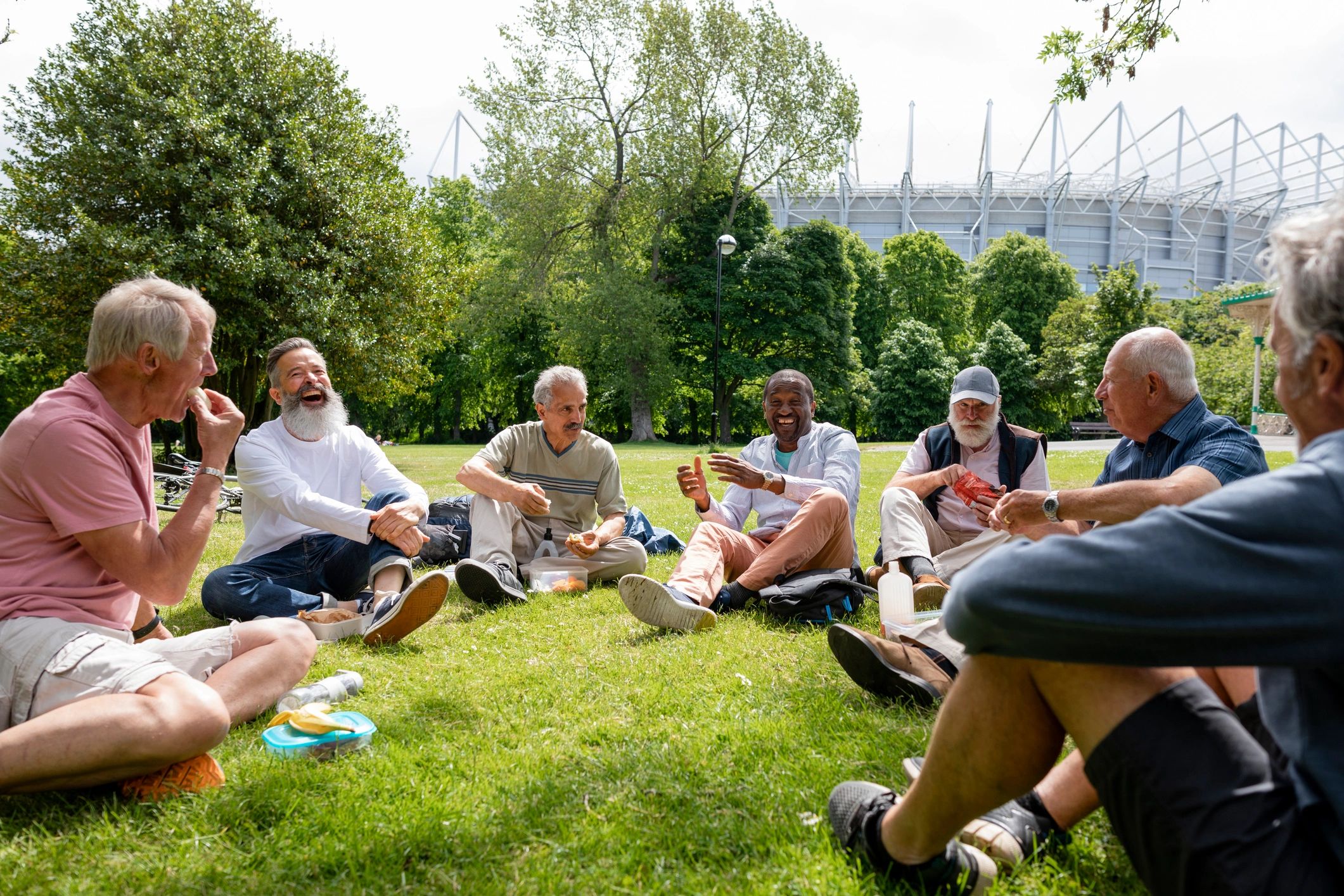 Adults relaxing together outdoors during a wellness-style group gathering